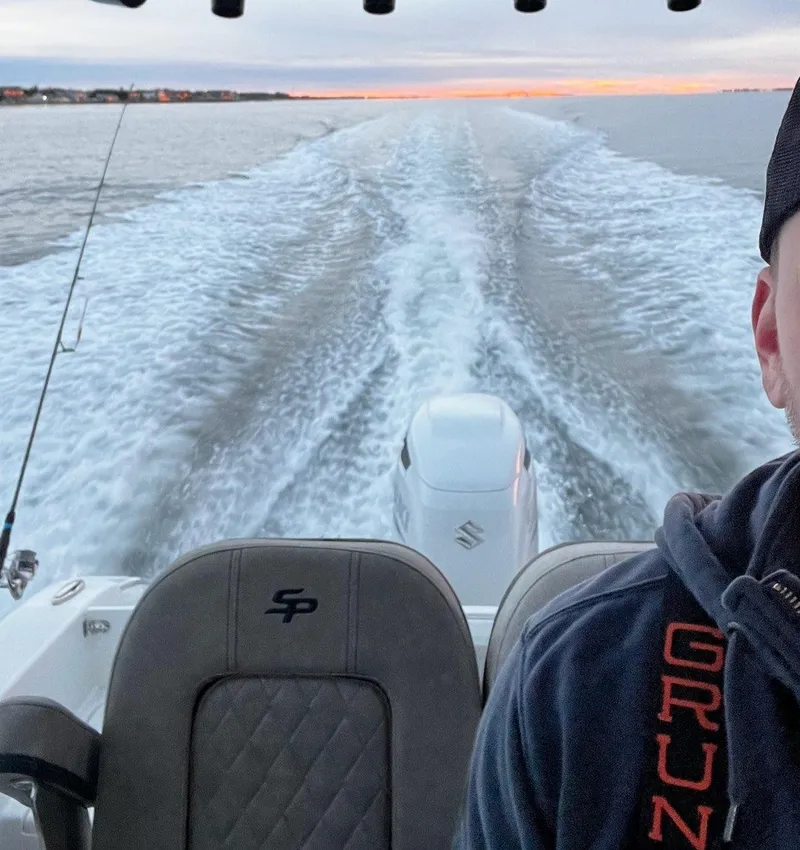 Slide: The Image of 2022 Sea Pro 239 Center Console boat interior with cushioned seating in showroom. - 5