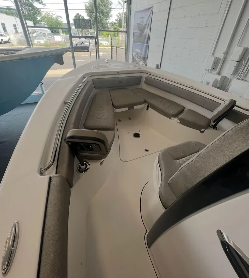 Slide: The Image of 2022 Sea Pro 239 Center Console boat on calm water, featuring comfortable seating. - 6