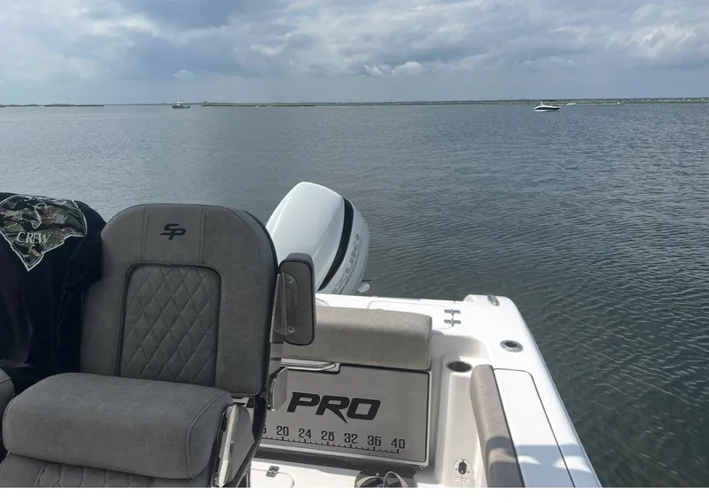 Slide: The Image of 2022 Sea Pro 239 Center Console boat cruising with visible wake and Suzuki outboard motor. - 7