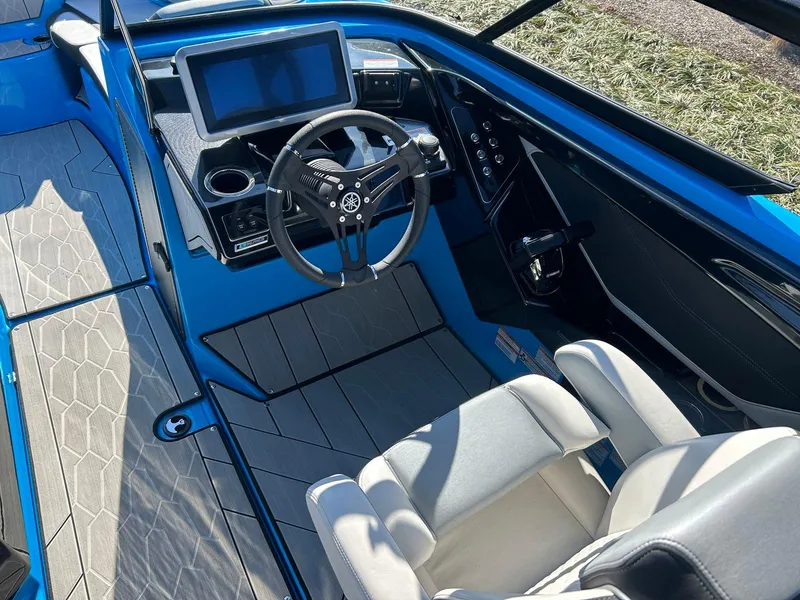 Slide: The Image of 2023 Yamaha Boats 255XD cockpit with steering wheel, touchscreen, and modern seating. - 10