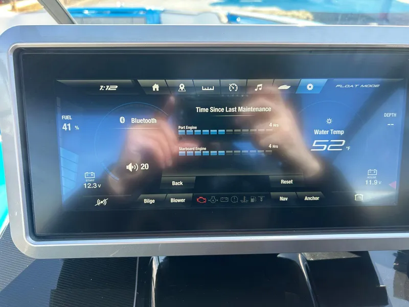 Slide: The Image of 2023 Yamaha Boats 255XD dashboard display showing fuel, Bluetooth, and water temperature. - 13