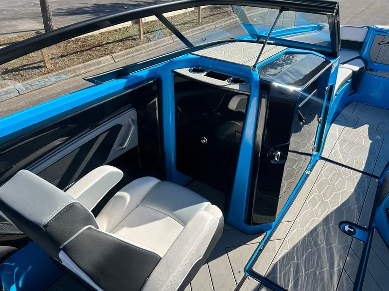 Slide: The Image of 2023 Yamaha Boats 255XD interior with blue accents, modern seating, and sleek design. - 8