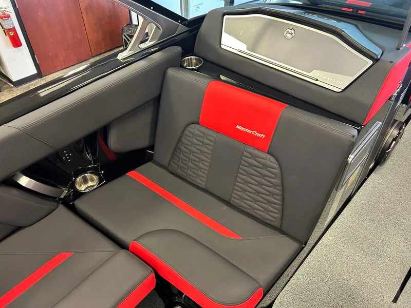 Slide: The Image of 2020 MasterCraft X22 interior with black and red seating, showcasing luxury design. - 11