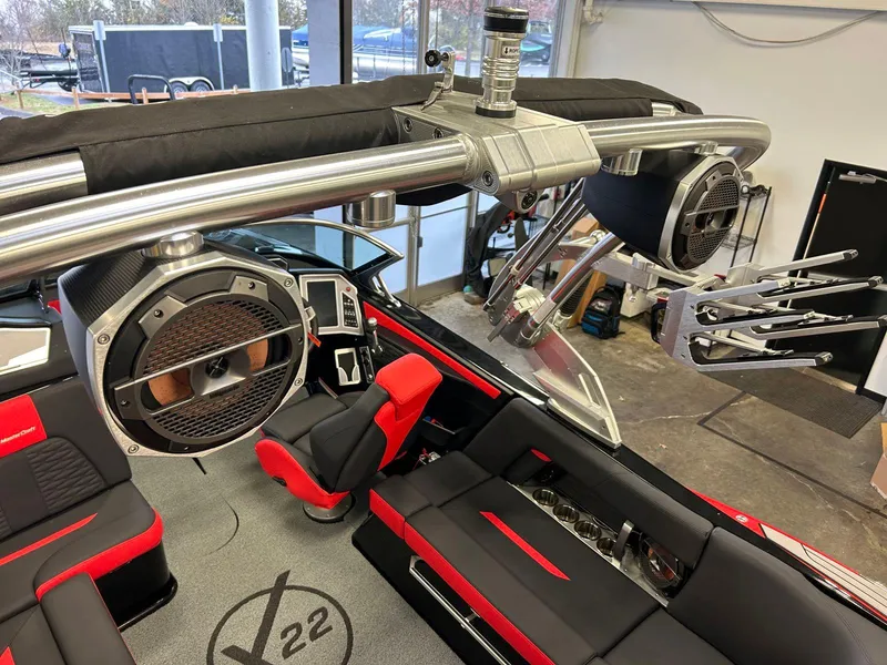 Slide: The Image of 2020 MasterCraft X22 interior with red and black seating, advanced audio system, and sleek design. - 15