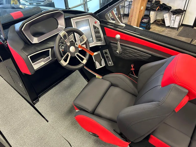 Slide: The Image of 2020 MasterCraft X22 boat interior with red and black seating and modern dashboard. - 7