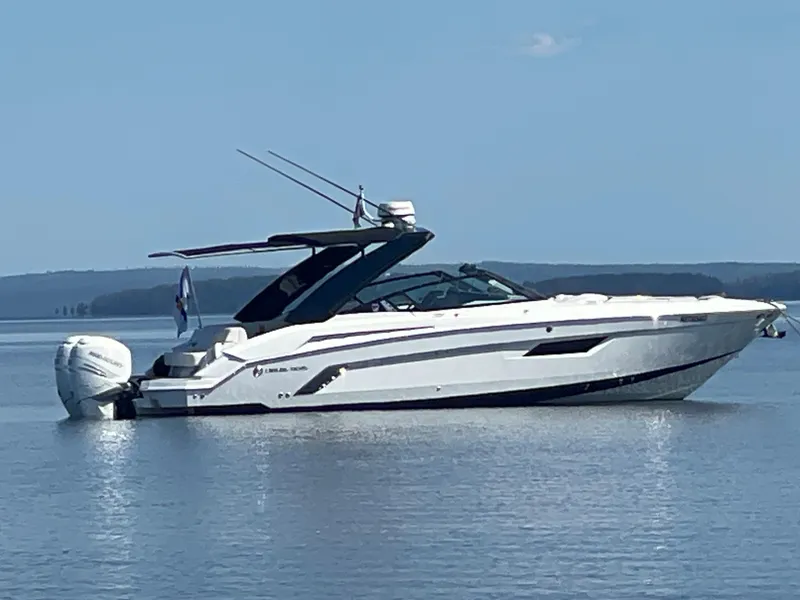 Slide: The Image of 2020 Cruisers Yachts 338OB boat on calm water, side view. - 2