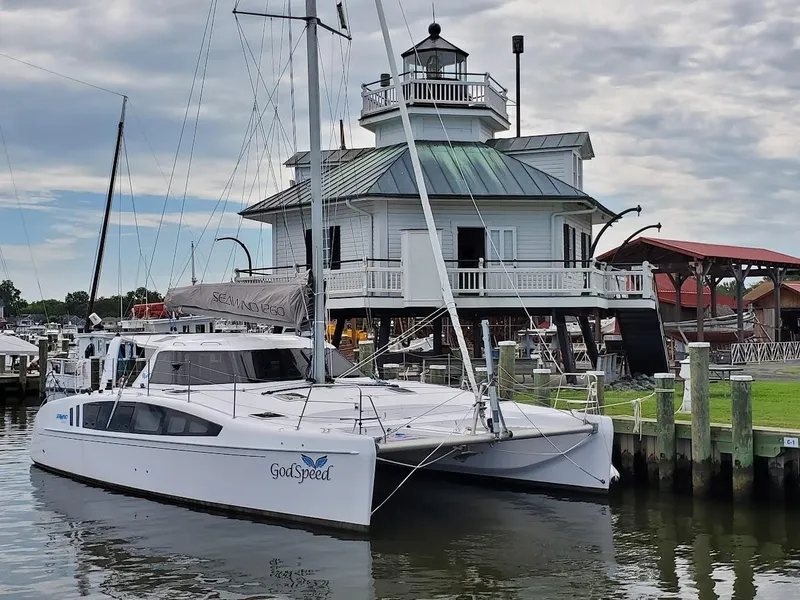 The Image of 2020 Seawind 1260 catamaran docked near a historic lighthouse. - 0