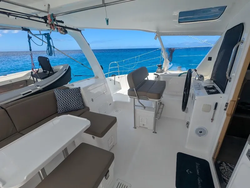 Slide: The Image of 2020 Seawind 1260 catamaran interior with ocean view, featuring seating and navigation area. - 10