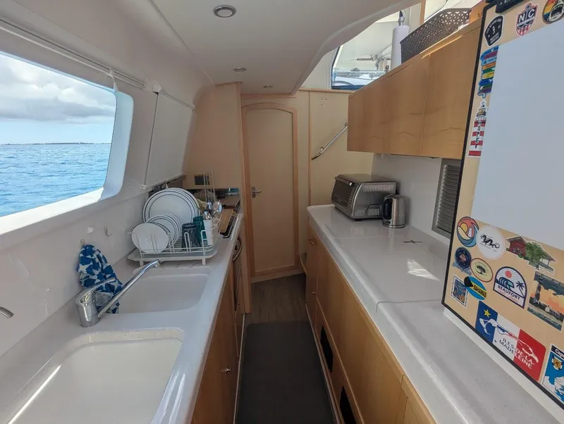 Slide: The Image of Interior of a 2020 Seawind 1260 catamaran kitchen with ocean view. - 18