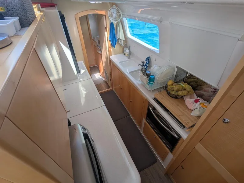 Slide: The Image of Interior of 2020 Seawind 1260 catamaran, featuring a modern kitchen with ocean view. - 19
