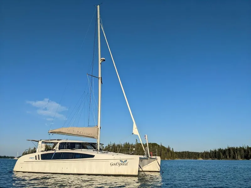 Slide: The Image of 2020 Seawind 1260 catamaran sailing on calm waters under clear blue sky. - 2