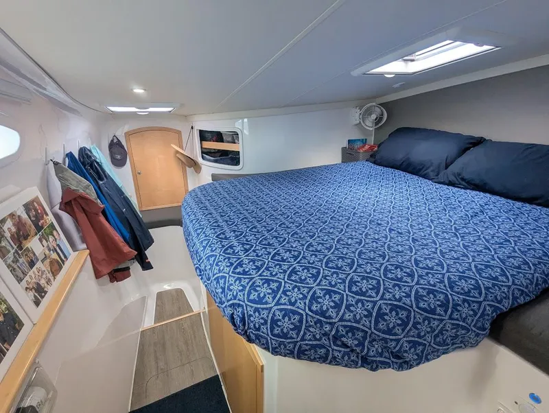Slide: The Image of Seawind 1260 2020 interior cabin with cozy bed and nautical decor. - 25