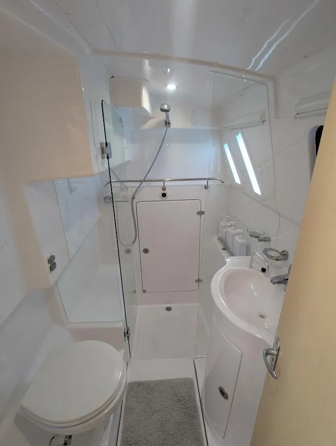 Slide: The Image of Modern bathroom in 2020 Seawind 1260 catamaran, featuring shower, sink, and toilet. - 30