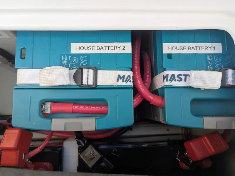 Slide: The Image of House batteries on a 2020 Seawind 1260 catamaran, secured with straps. - 32