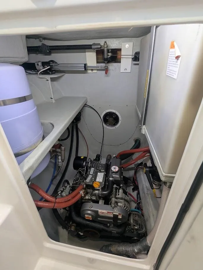 Slide: The Image of Engine compartment of a 2020 Seawind 1260 catamaran, showcasing mechanical components and wiring. - 33