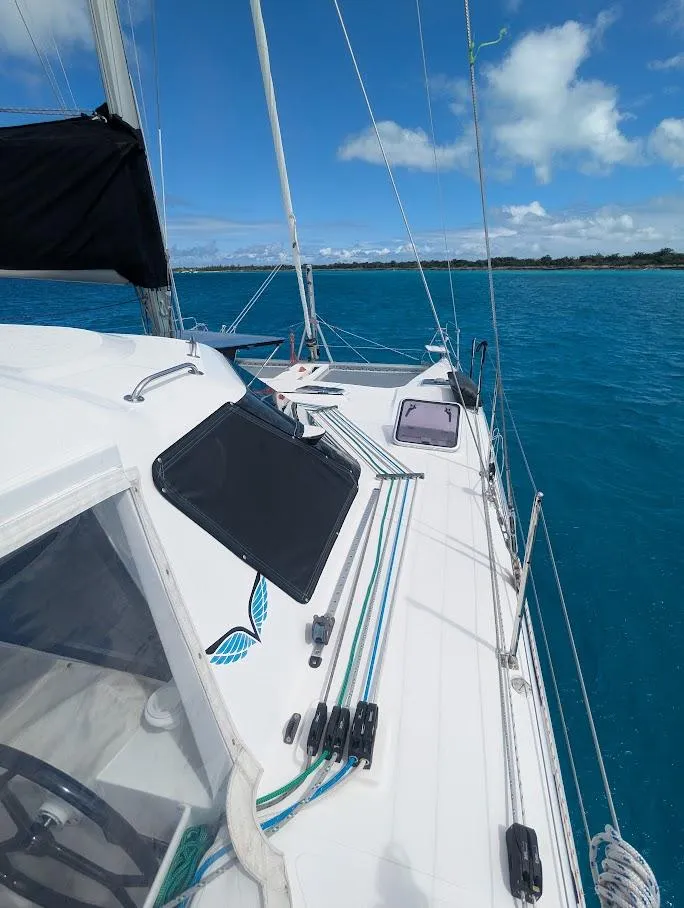Slide: The Image of 2020 Seawind 1260 catamaran sailing on clear blue waters under a bright sky. - 6
