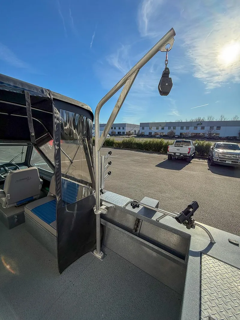 Slide: The Image of 2011 Pro-Steelheader 18 Sea Predator OS boat with crane arm, parked outdoors. - 20