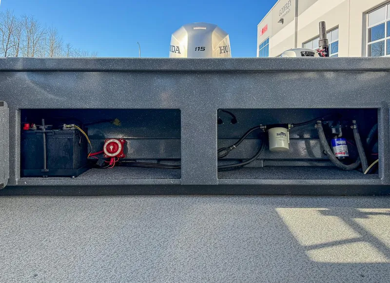 Slide: The Image of 2011 Pro-Steelheader 18 Sea Predator OS boat engine compartment with battery and fuel filter. - 22