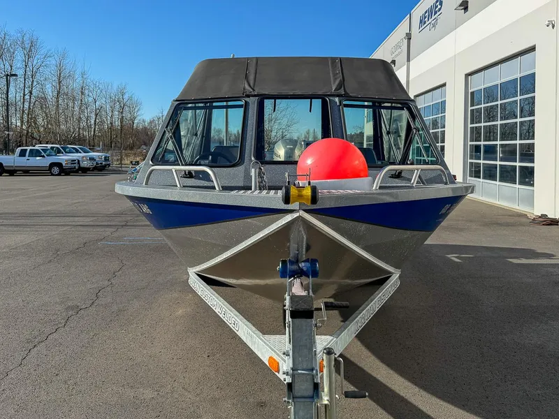 Slide: The Image of 2011 Pro-Steelheader 18 Sea Predator OS boat on trailer, parked outside dealership. - 8