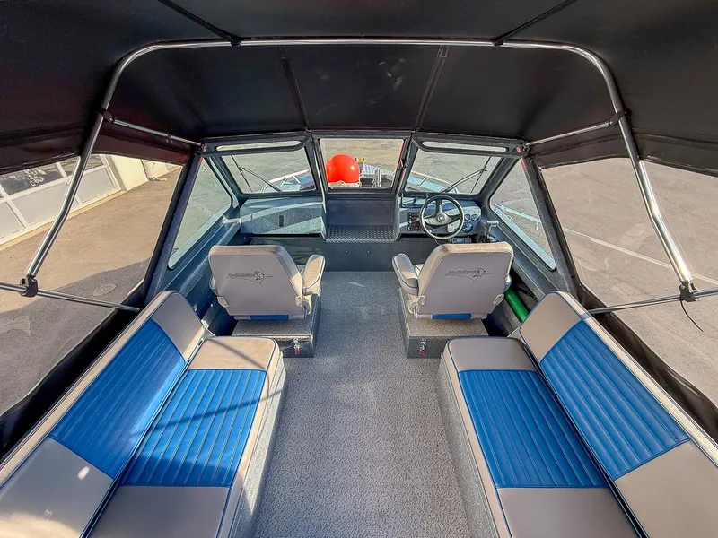 Slide: The Image of Interior of 2011 Pro-Steelheader 18 Sea Predator OS boat with blue seating. - 9