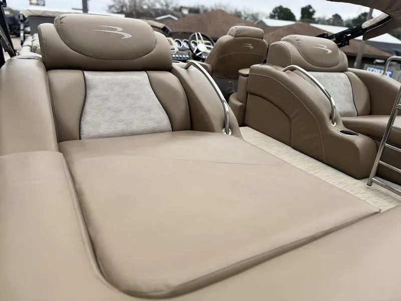 Slide: The Image of Luxurious seating on 2016 Bennington 2575 QCW I/O boat, featuring beige upholstery. - 14