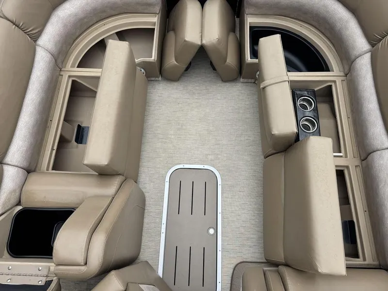 Slide: The Image of Interior of 2016 Bennington 2575 QCW I/O boat with beige seating and cup holders. - 21