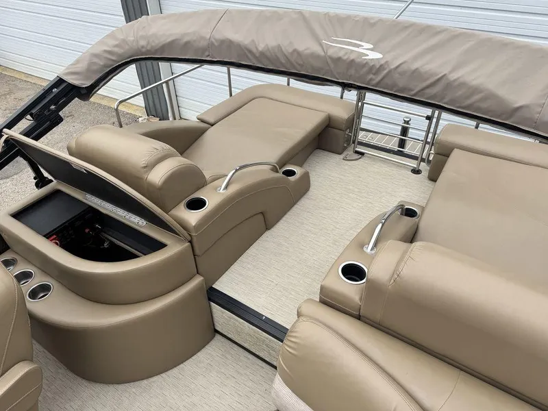 Slide: The Image of 2016 Bennington 2575 QCW I/O boat interior with beige seating and cup holders. - 23