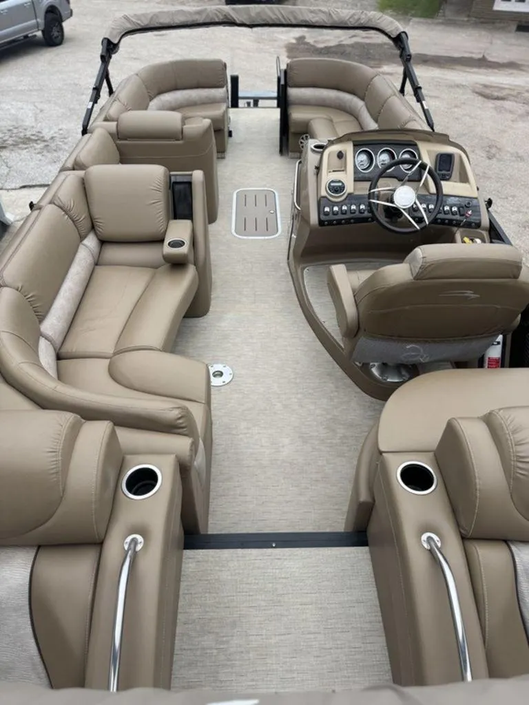 Slide: The Image of 2016 Bennington 2575 QCW I/O pontoon boat interior with luxurious seating and modern dashboard. - 5