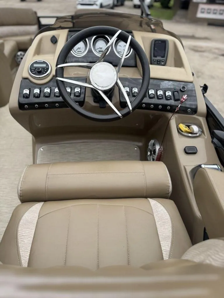 Slide: The Image of 2016 Bennington 2575 QCW I/O boat dashboard with steering wheel and control panel. - 6