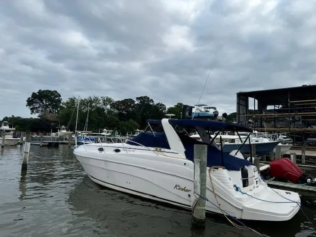 Slide: The Image of 2004 Rinker Fiesta Vee 342 boat docked at marina under cloudy sky. - 3