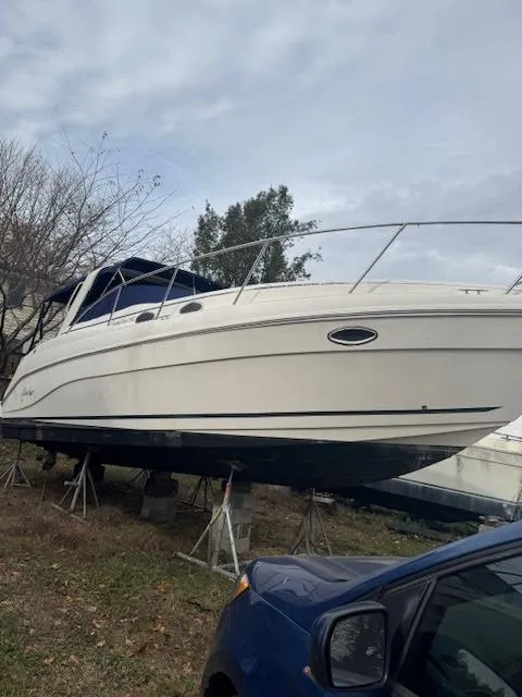 Slide: The Image of 2004 Rinker Fiesta Vee 342 boat on stands, outdoors, with overcast sky. - 6