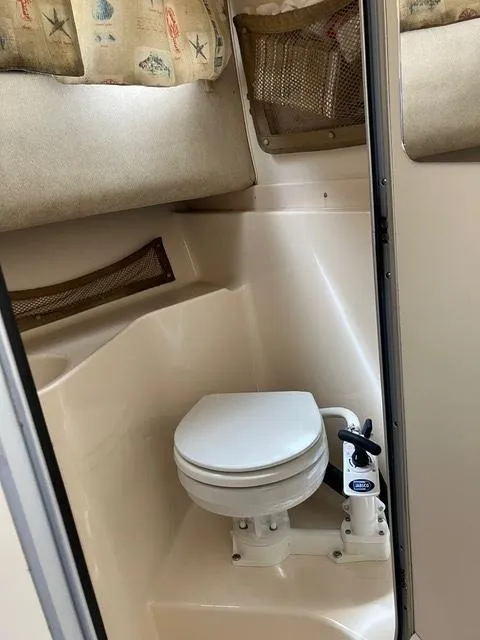 Slide: The Image of 2003 Grady-White Sailfish 282 boat interior with compact marine toilet. - 10