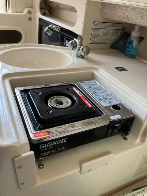 Slide: The Image of 2003 Grady-White Sailfish 282 boat kitchen with GloMate stove and sink. - 12