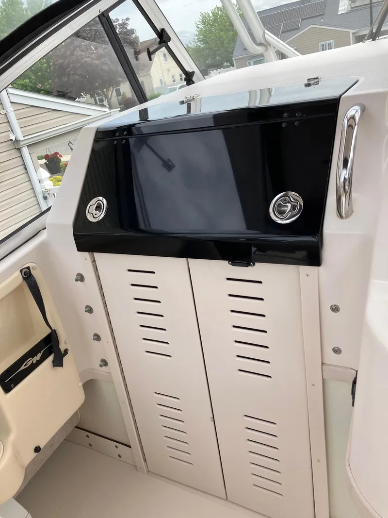 Slide: The Image of 2003 Grady-White Sailfish 282 boat interior console with storage compartments. - 16