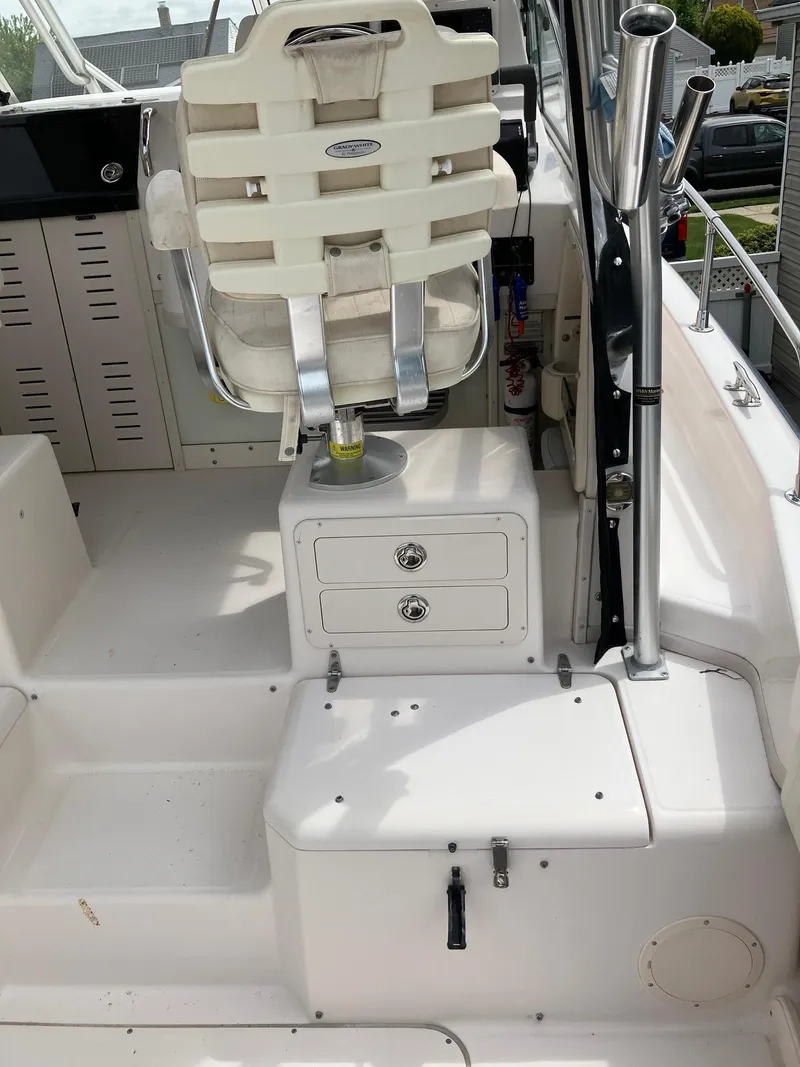 Slide: The Image of 2003 Grady-White Sailfish 282 boat interior with captain's chair and storage compartments. - 17