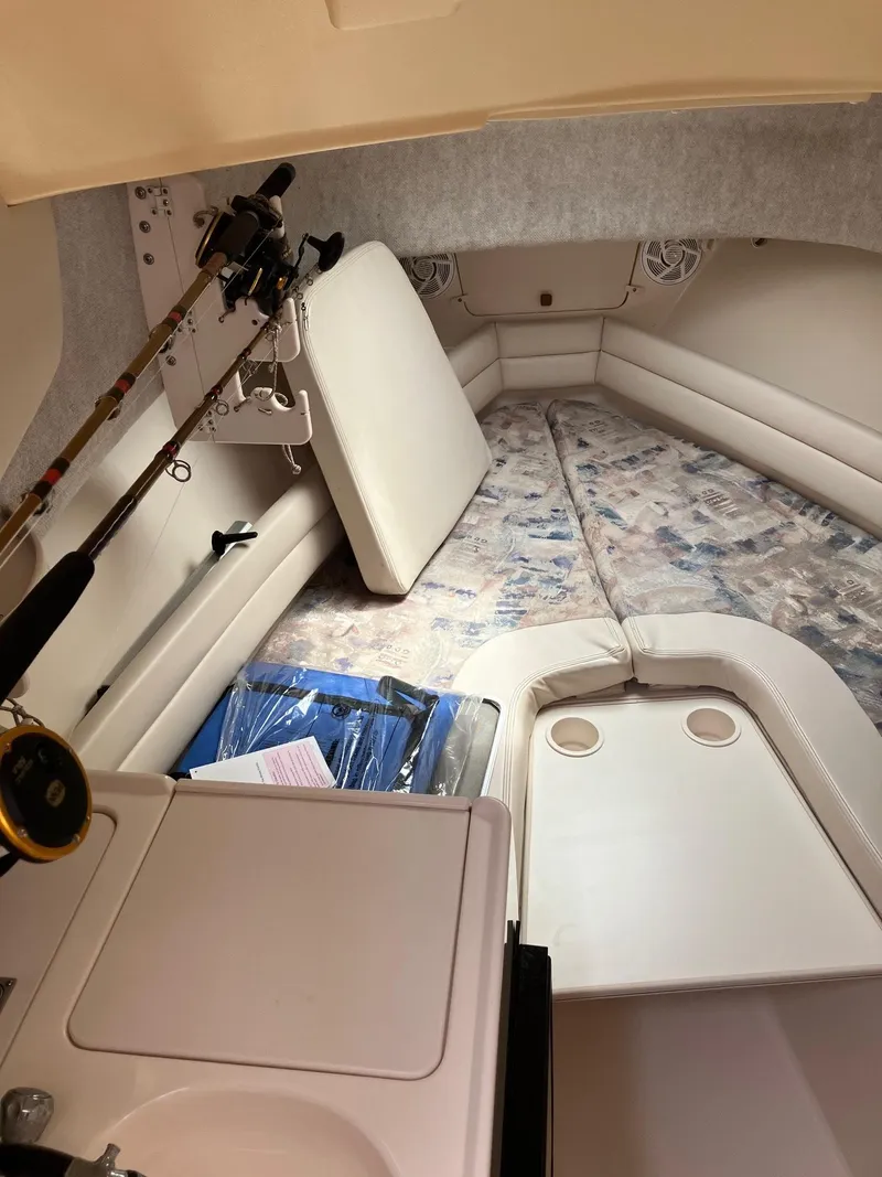 Slide: The Image of 2003 Grady-White Sailfish 282 cabin interior with fishing rods and seating area. - 18