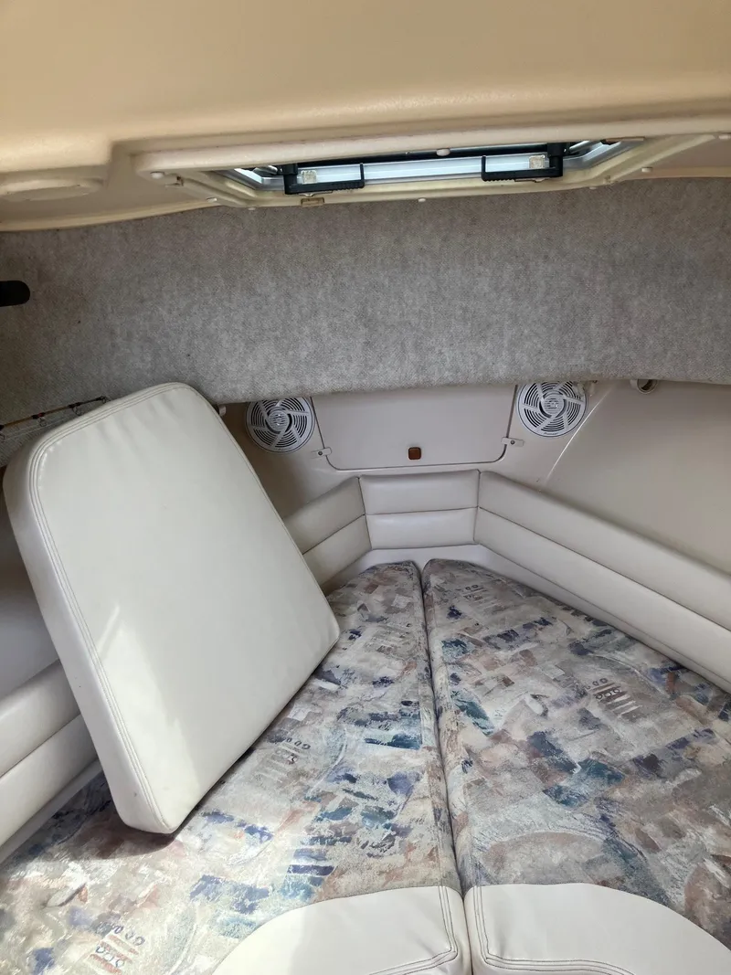 Slide: The Image of Interior cabin of 2003 Grady-White Sailfish 282 boat, featuring cushioned seating and overhead hatch. - 19