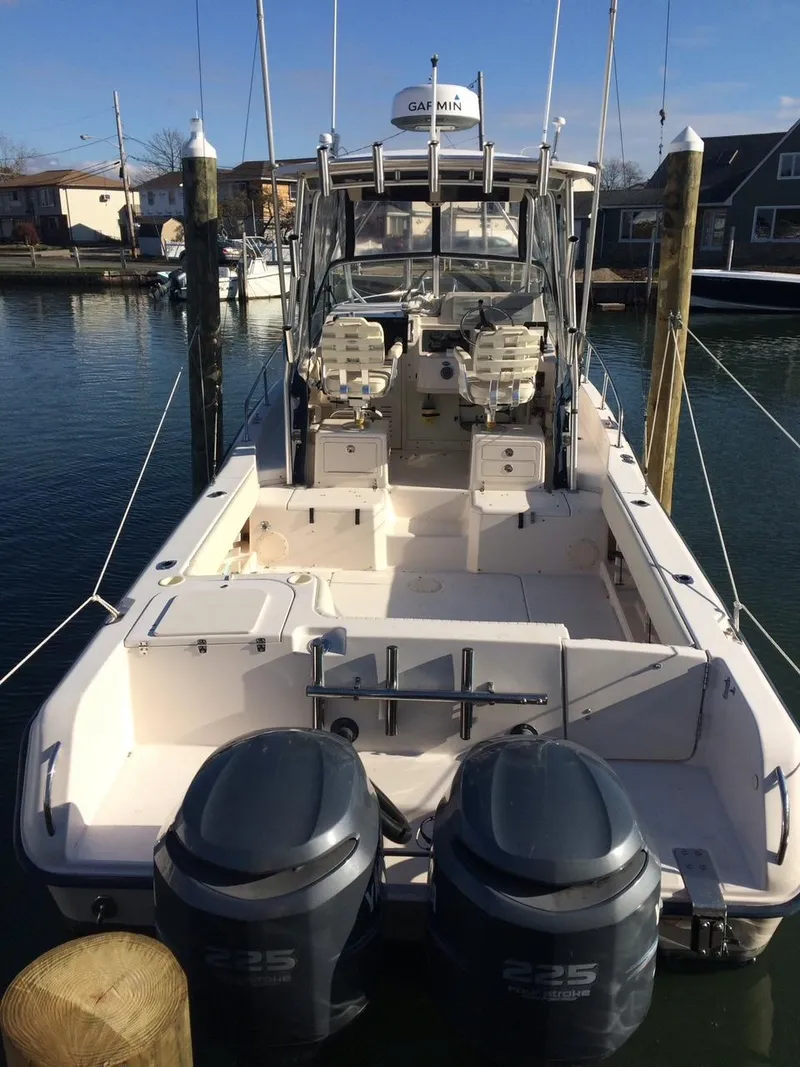 Slide: The Image of 2003 Grady-White Sailfish 282 boat with dual engines docked at marina. - 2