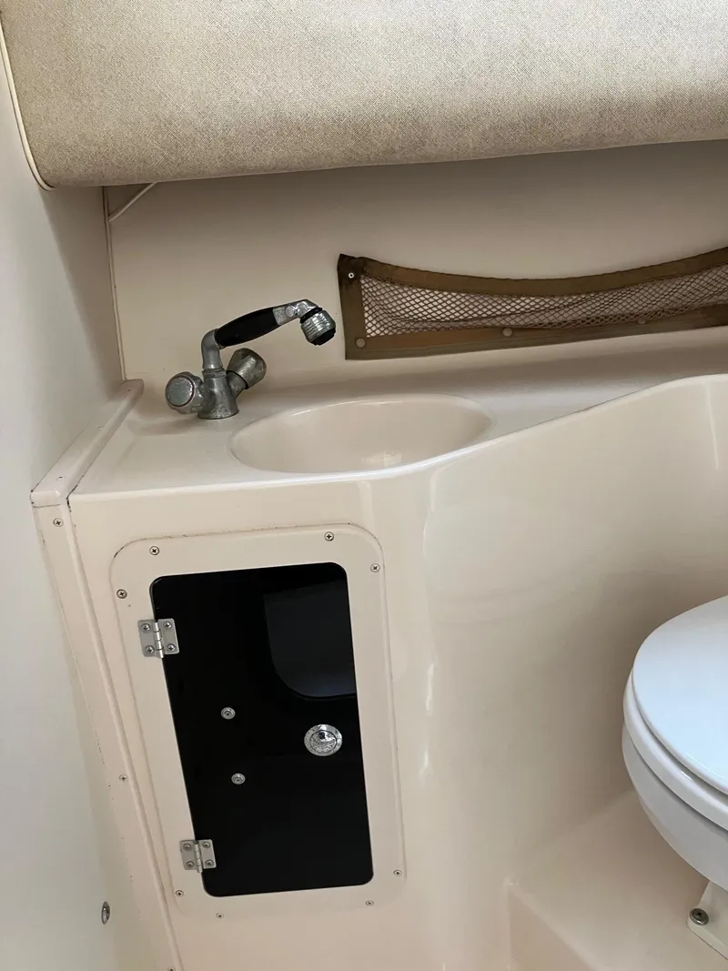 Slide: The Image of 2003 Grady-White Sailfish 282 boat interior with sink and storage cabinet. - 20