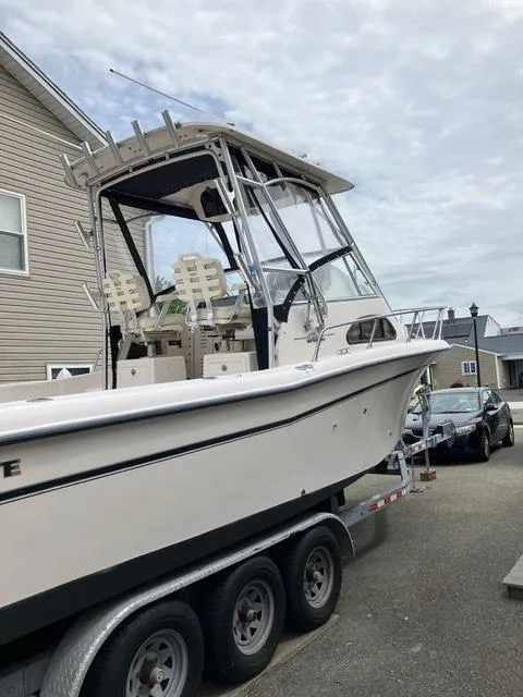 Slide: The Image of 2003 Grady-White Sailfish 282 boat on trailer, parked in residential area. - 3