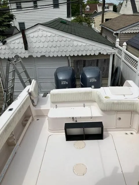 Slide: The Image of 2003 Grady-White Sailfish 282 boat with twin 225 engines, parked near a garage. - 4