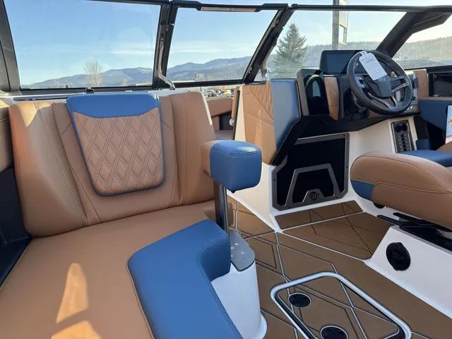 Slide: The Image of 2025 Malibu M230 boat interior with luxurious seating and modern dashboard design. - 13