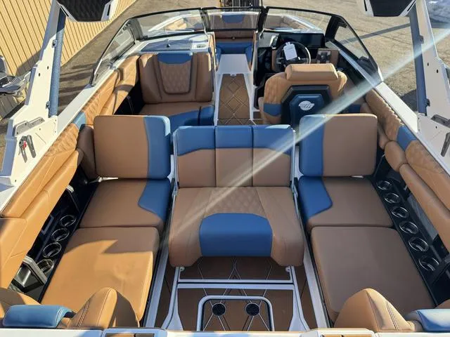 Slide: The Image of Luxurious interior of 2025 Malibu M230 boat with tan and blue seating. - 14