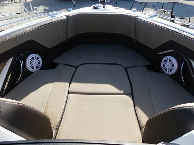 Slide: The Image of 2025 Monterey 255SS boat interior with beige seating and built-in speakers. - 19