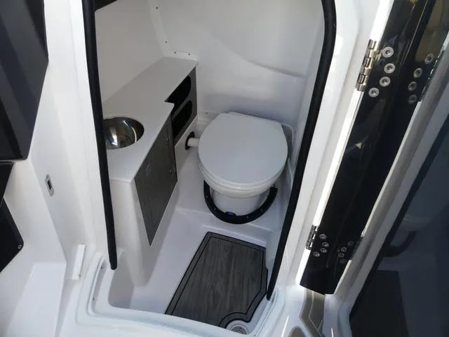 Slide: The Image of Interior of 2025 Monterey 255SS boat bathroom with toilet and sink. - 20