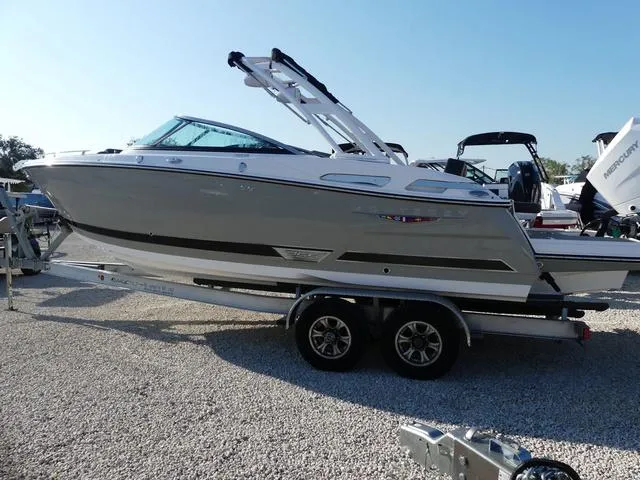 Slide: The Image of 2025 Monterey 255SS boat on trailer, displayed outdoors under clear sky. - 4