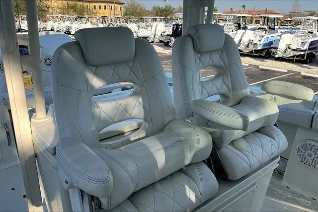 Slide: The Image of Luxurious seating on a 2016 Hydra-Sports 3400 CC boat, featuring plush, diamond-stitched upholstery. - 10