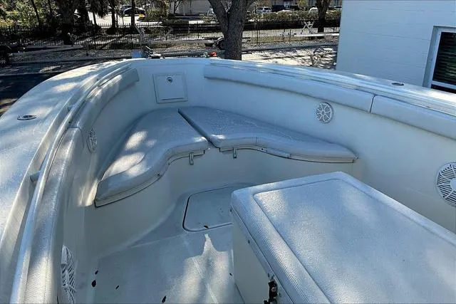 Slide: The Image of 2016 Hydra-Sports 3400 CC boat interior with cushioned seating and storage compartments. - 16