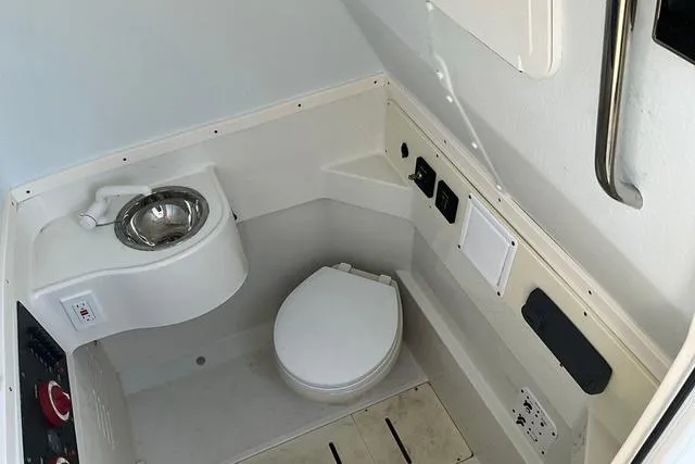 Slide: The Image of 2016 Hydra-Sports 3400 CC boat interior bathroom with sink and toilet. - 21