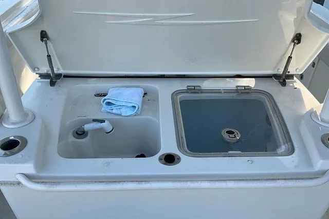 Slide: The Image of 2016 Hydra-Sports 3400 CC boat sink and storage area with a folded towel. - 23